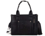 Wrangler Women's Cow Print Concealed Carry Tote & Crossbody Bag in black with cow print detailing