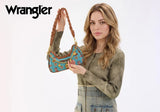 Model showcasing Wrangler Women's Western Cowboy Print Shoulder Bag in Turquoise with decorative charms.