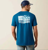 Ariat Men's Liquid Stamp Flag T-Shirt in Sailor Blue, showcasing a bold flag graphic on the back.