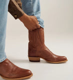 Man putting on Tecovas The Cartwright Men's Cowboy Boot made of Scotch Goat leather.
