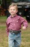 Cinch Toddler Boy's Long Sleeve Geometric Print Snap Shirt in pink, worn by a smiling boy in a natural setting.