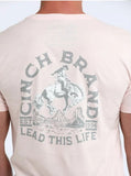 Cinch Men's "Lead This Life" Graphic Tee in blush pink, featuring bucking horse graphic on back.