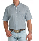 Cinch Men's Arenaflex Short Sleeve Shirt in blue with cream buttons and open pocket, styled with denim jeans.