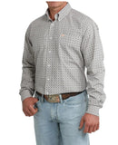 Model wearing Cinch Men's Long Sleeve White Printed Button Up Shirt, showcasing its stylish design and button-down collar.