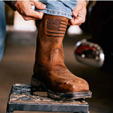 Ariat WorkHog XT Patriot Waterproof Carbon Toe Work Boot with American flag design in a workspace.