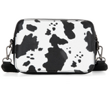 Wrangler cow print crossbody purse showcasing bold pattern and purse design with removable strap.