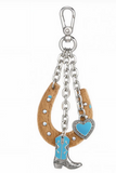 Wrangler Western cowhide horseshoe bag charm featuring turquoise accents and a decorative cowboy boot.