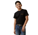 Young boy wearing black Ariat Youth Barn Shield T-Shirt and jeans, showcasing the bold Ariat logo.