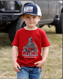 Cinch Infant Boys Short Sleeve Graphic Tee in burgundy worn by a young boy with a truck in the background.
