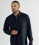 Tecovas Men's Performance Western Pearl Snap Long Sleeve Shirt in Black worn by a model, showcasing stylish design and functionality.