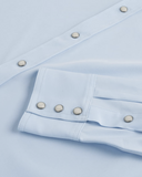 Close-up of Tecovas Men's Performance Western Shirt in Sky color with snap buttons and cuff detail.