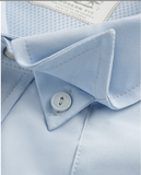 Close-up of Tecovas Men's Performance Western Short Sleeve Pearl Snap Shirt in Sky color, highlighting the collar and button details.