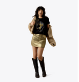 Ariat Women's Wild West Short Sleeve Graphic T-Shirt styled with a gold skirt and black boots.
