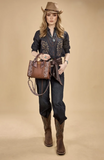 Wrangler Women's Braided Paisley Bag showcased with denim outfit and cowboy hat, emphasizing style and versatility.