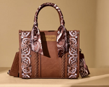Wrangler Women's Braided Paisley Bandana Tote Crossbody Bag in brown with paisley design and detachable strap.