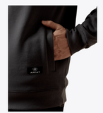 Close-up of Ariat Men's Core 1/4 Zip Sweatshirt in Dark Shadow with hand in pocket.