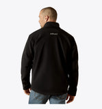 Back view of a man wearing the Ariat Men's Vernon Softshell Jacket, showcasing the stylish design and brand logo.