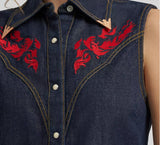 Wrangler Lainey Wilson X Embroidered Sleeveless Denim Shirt featuring bold red flame embroidery on indigo fabric.