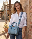 Woman wearing Wrangler Women's Paisley Print Tote Crossbody Bag in Desert Jean Paisley style.