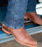 Tecovas The Earl Men's Roper Boot in Scotch Goat leather, worn with jeans on a truck step.