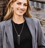 Montana Silversmiths Women's Between Luck Bolo Necklace worn by a model with a stylish outfit in a rustic setting.