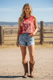 Rock & Roll Denim Women's Graphic Muscle Tank in Red worn with denim shorts and cowboy boots, perfect for a western style.